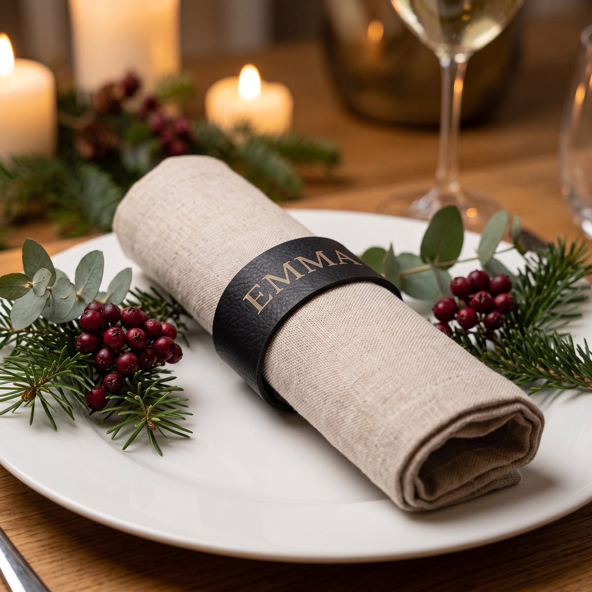 Personalised napkin ring engraved with the name Emma around a linen napkin on a Christmas place setting