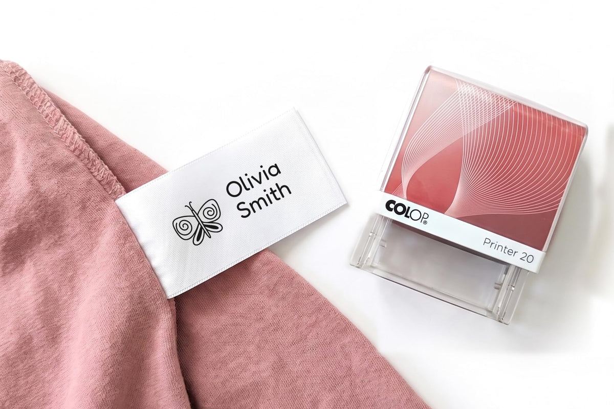 Personalised name stamp for clothes printing a child's name on a white care label