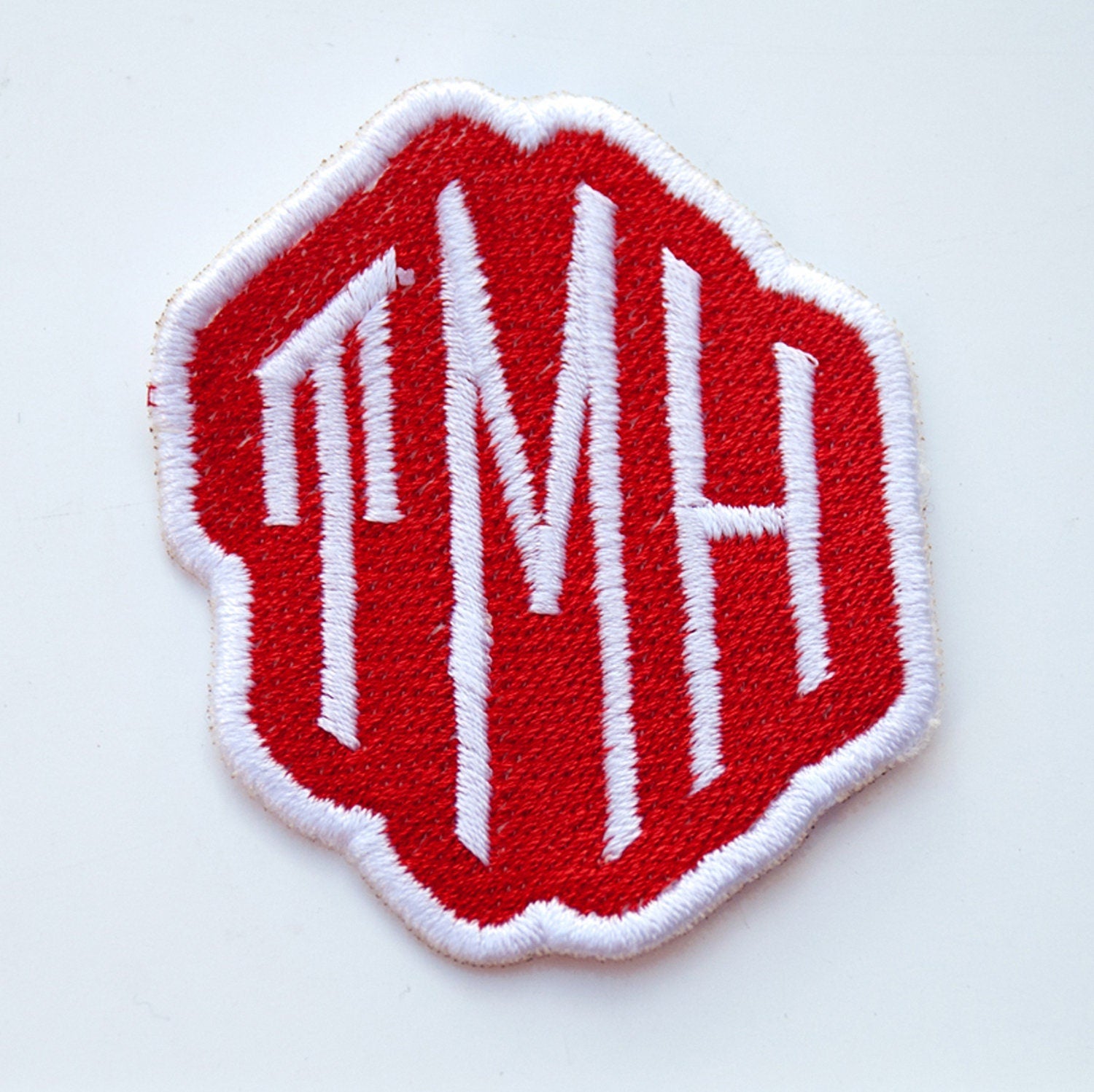 Personalised red embroidered monogram patch with initials TMH, perfect for bags, jackets, and personalized gifts.