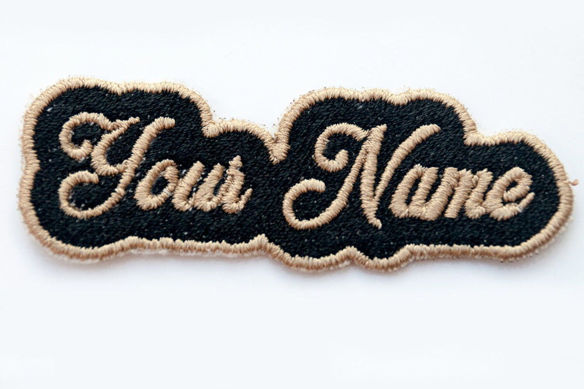 Personalized embroidered patch with black background and beige text, customizable for bags, jackets, and more.