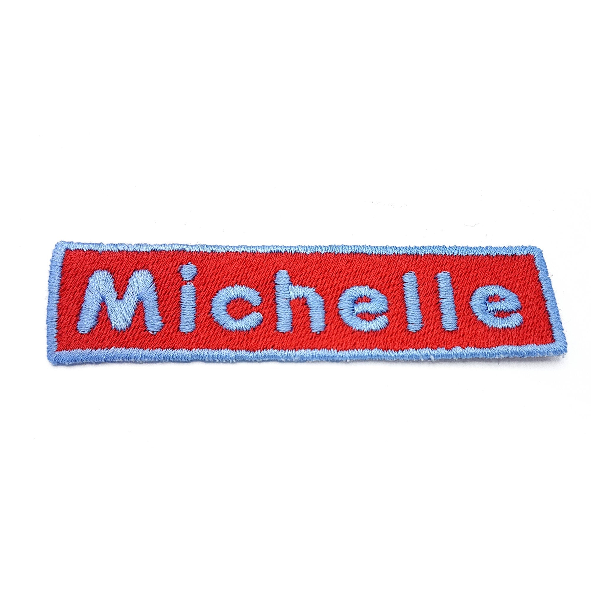 Personalized embroidered name patch for 'Michelle' in vibrant red and blue colors, ideal for bags and jackets.