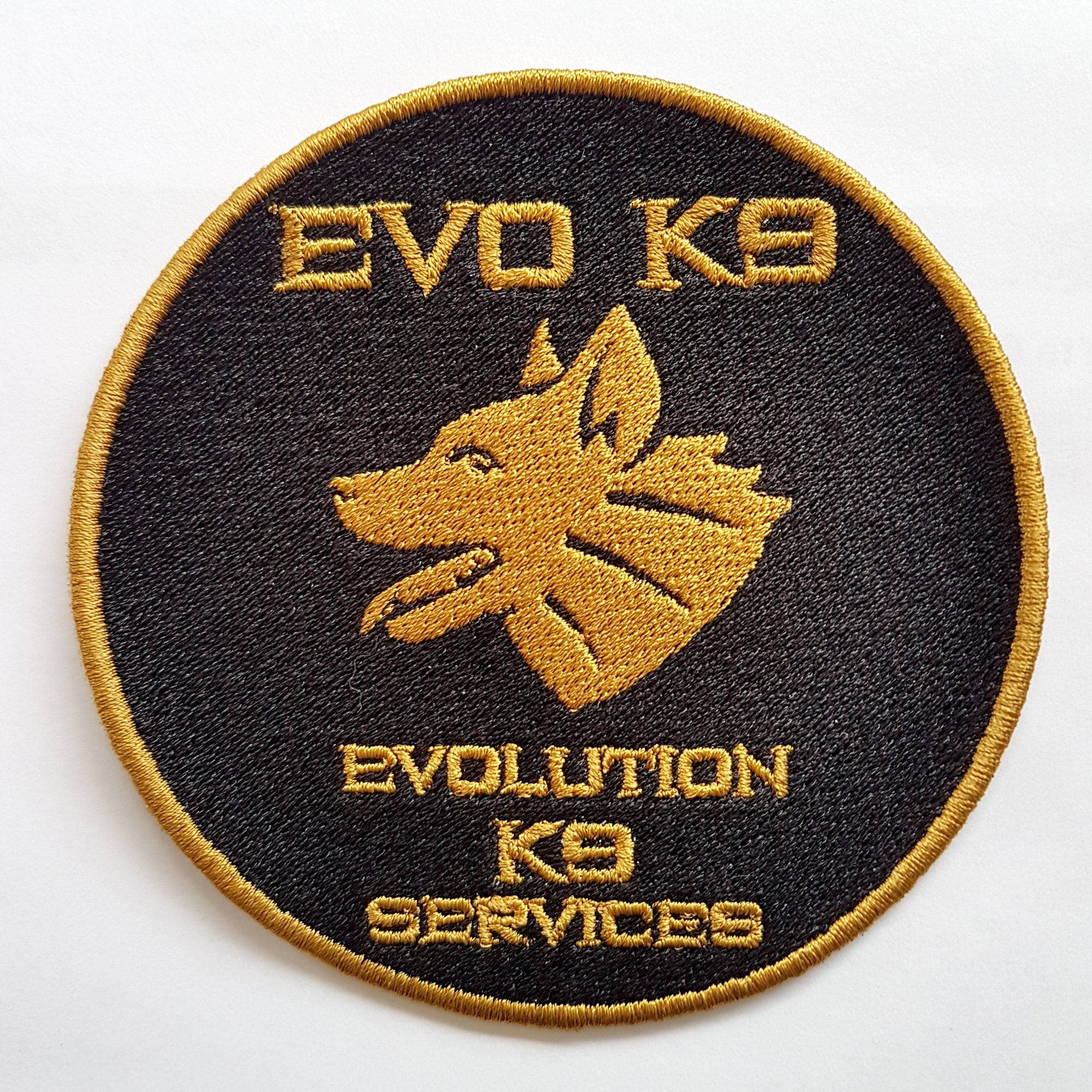 Embroidered patch featuring 'EVO K9' and a wolf head design for Evolution K9 Services.