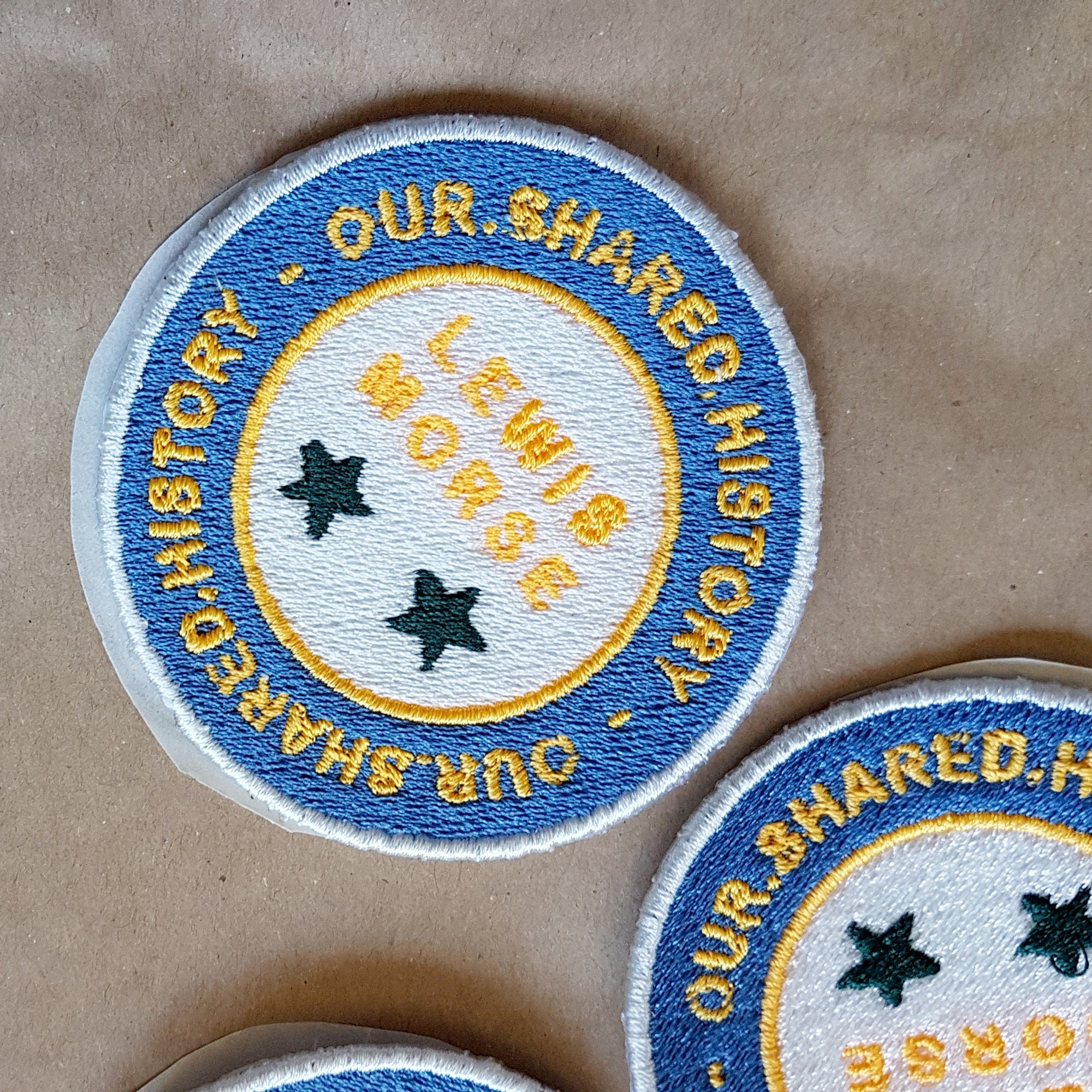 Personalized embroidered patch featuring the text 'Lewis Morse' and stars, highlighting shared history theme.