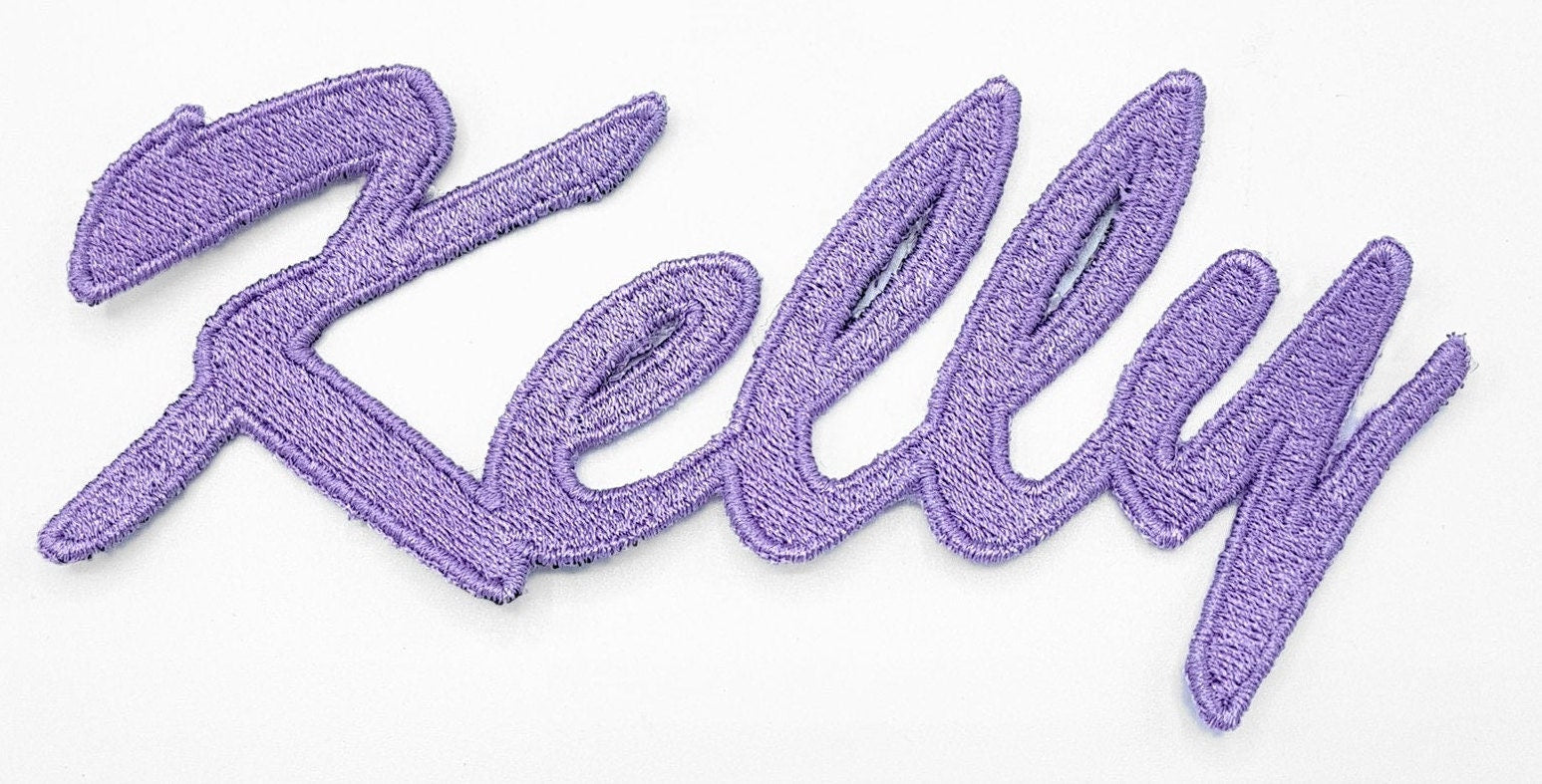 Embroidered personalized name patch with the name 'Kelly' in vibrant purple thread.
