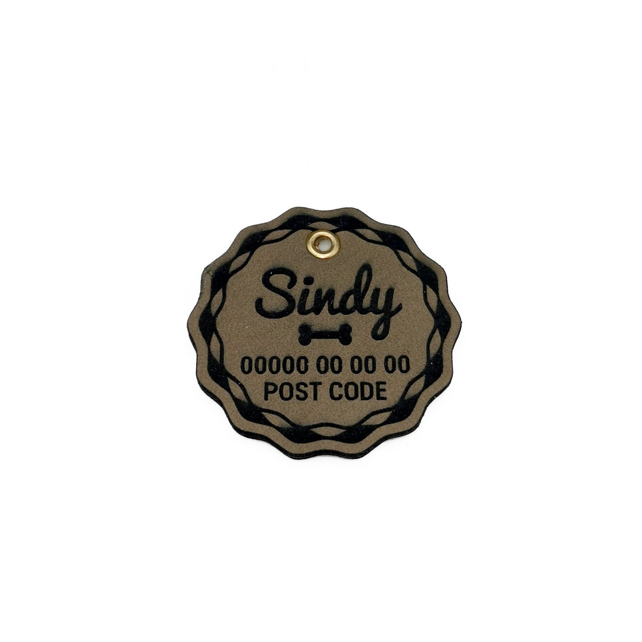 Custom leather dog name tag engraved with the name 'Sindy', double-sided and personalized with text.