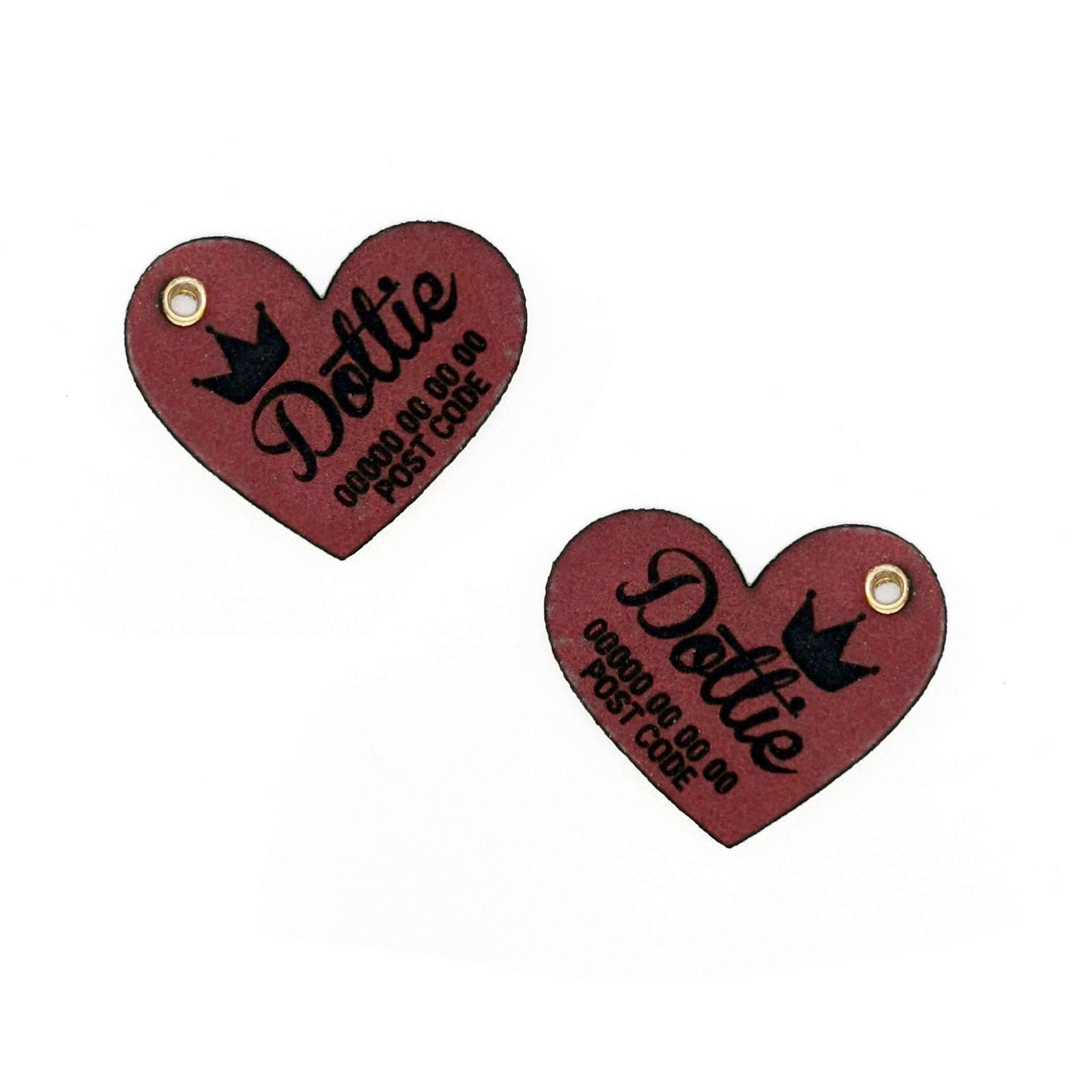 Custom leather heart-shaped dog name tag with engraved text and crown design.