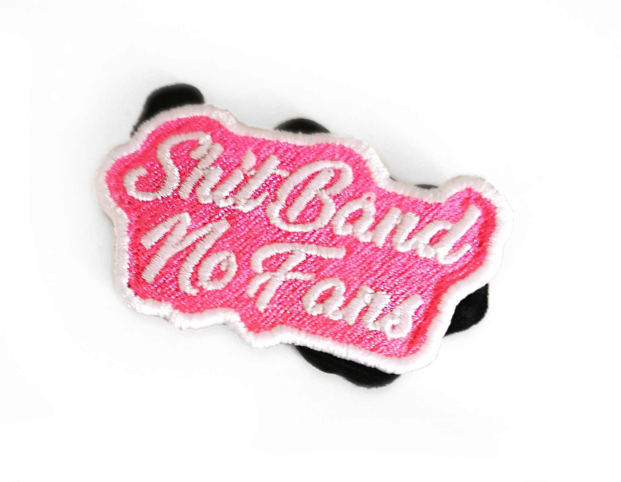 Custom embroidered patch with vibrant pink text 'Shit Bend No Fans' for bags and jackets.