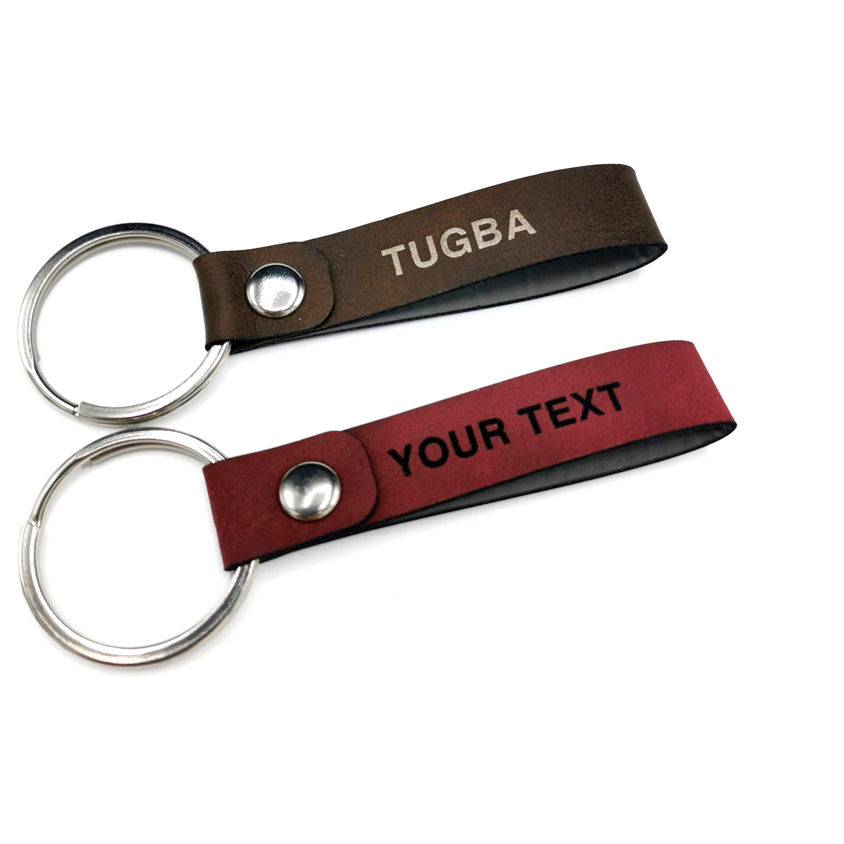Custom leather keyring with personalized engraving on both sides, featuring brown and red PU leather designs.
