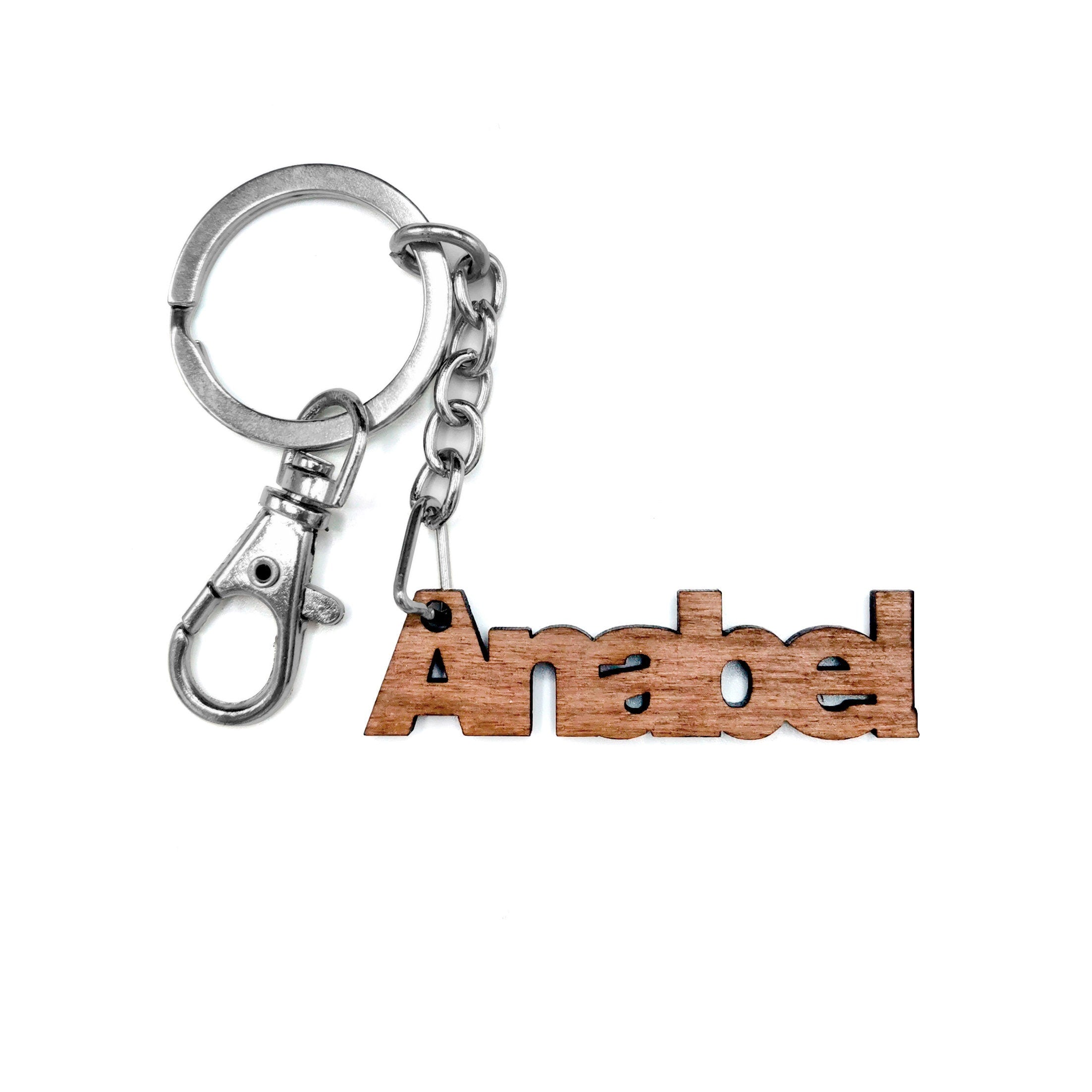 Custom solid walnut wood keyring with engraved name Anabel, featuring a metal keychain.