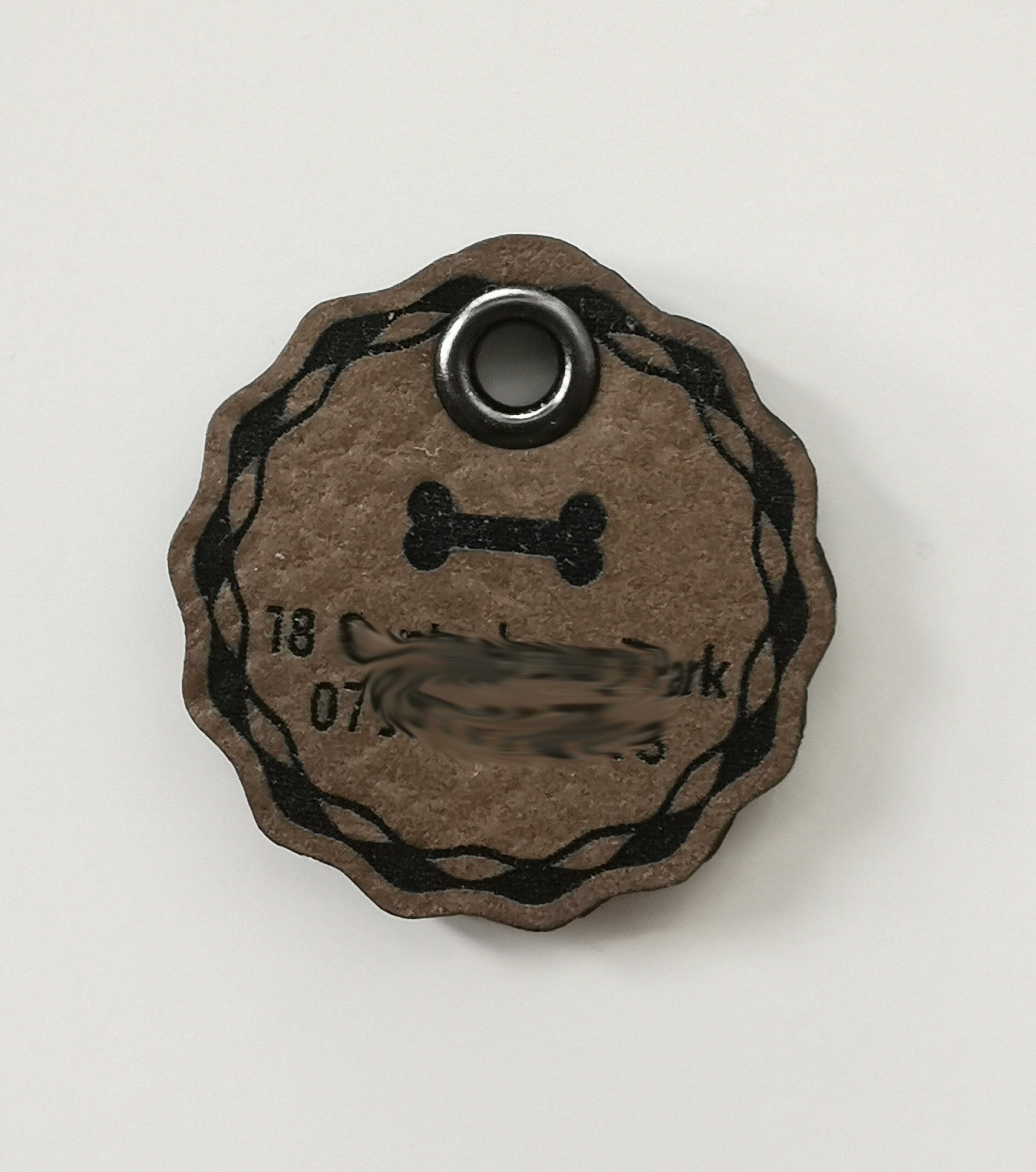 Custom leather dog name tag featuring a bone design, double-sided, laser engraved with indelible text.