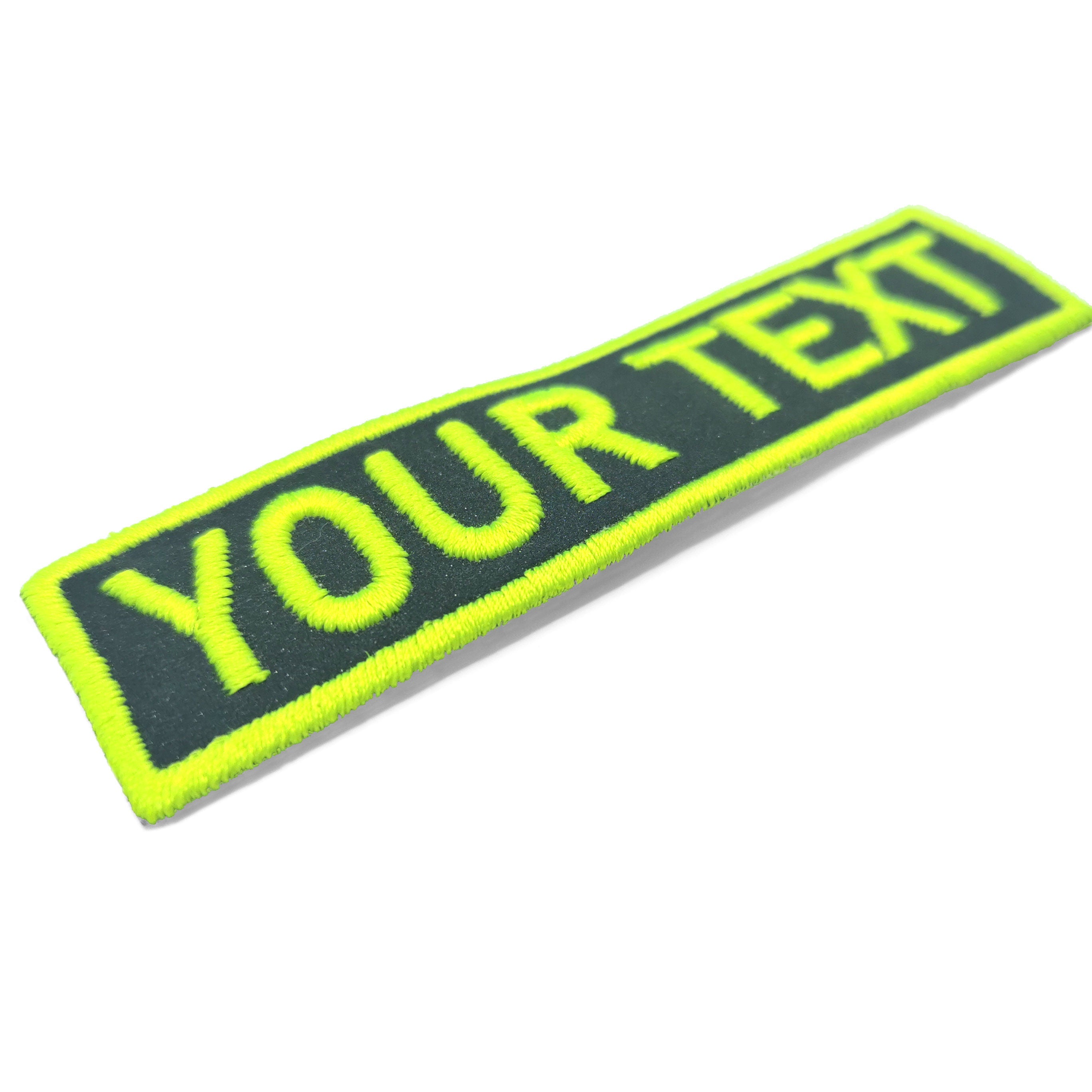 Custom reflective name patch with embroidered text on vibrant yellow and black fabric, ideal for personalization.