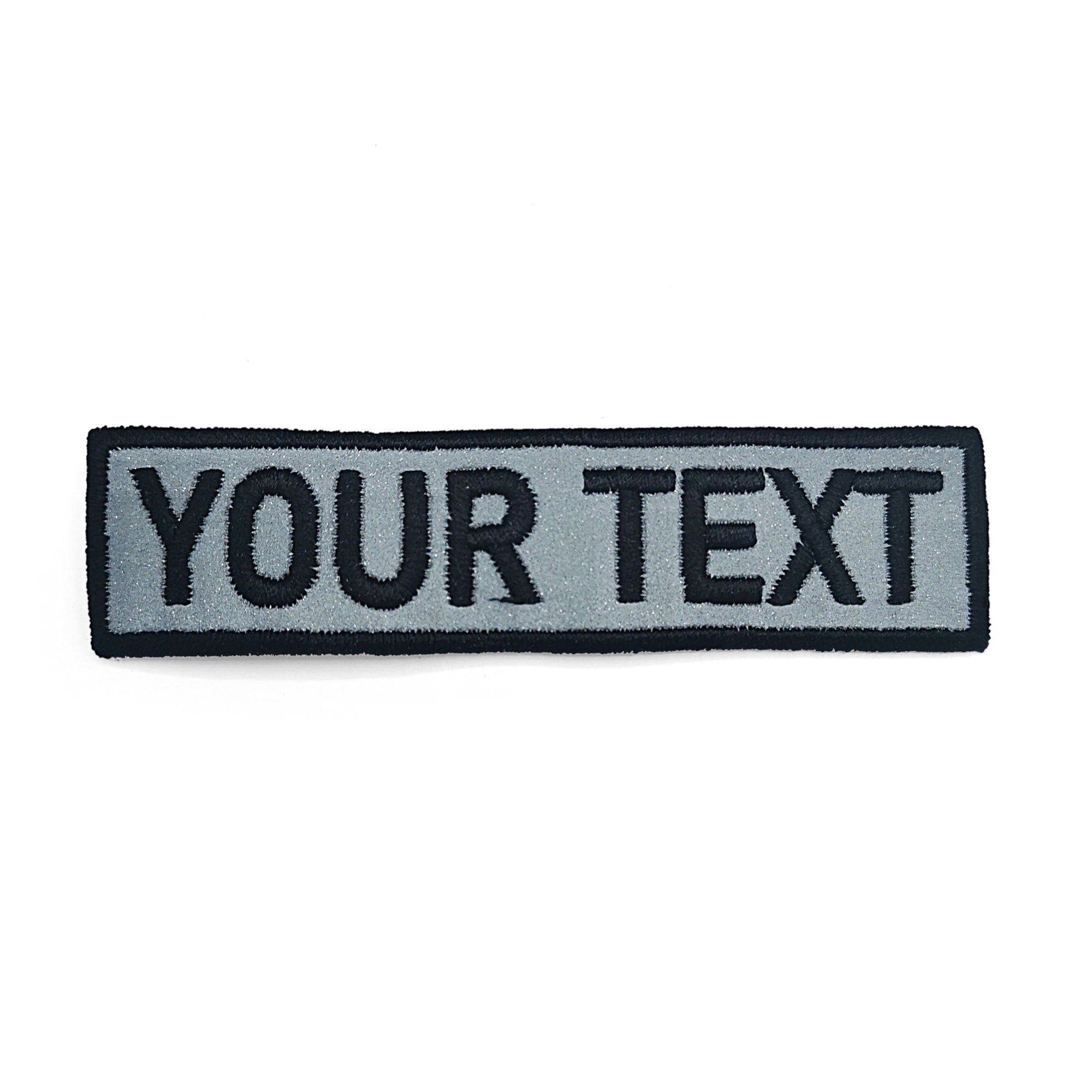 Custom reflective name patch with embroidered text, personalized and easy to apply, ideal for various uses.