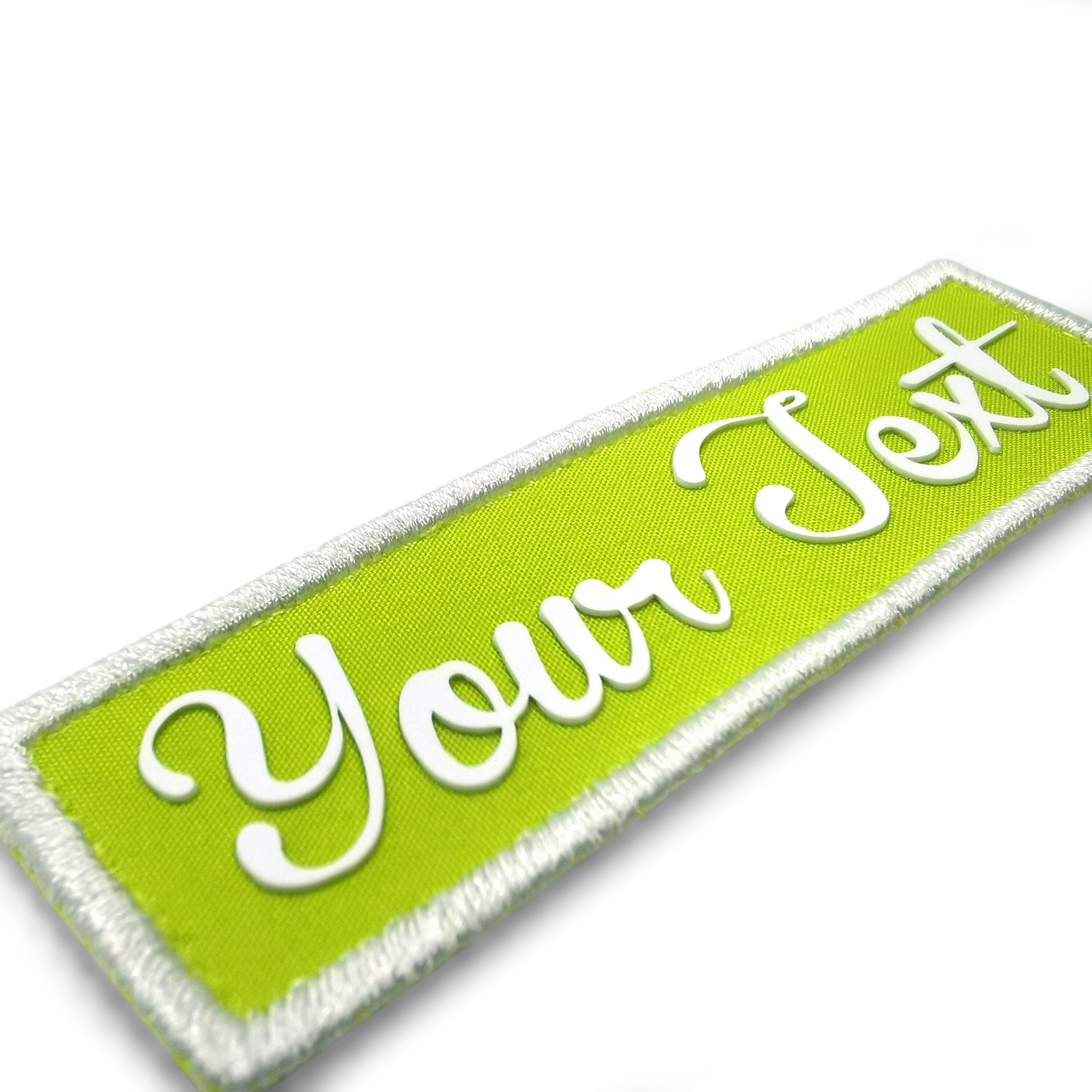 Custom 3D name silicone patch in vibrant green with white text and embroidered edges.