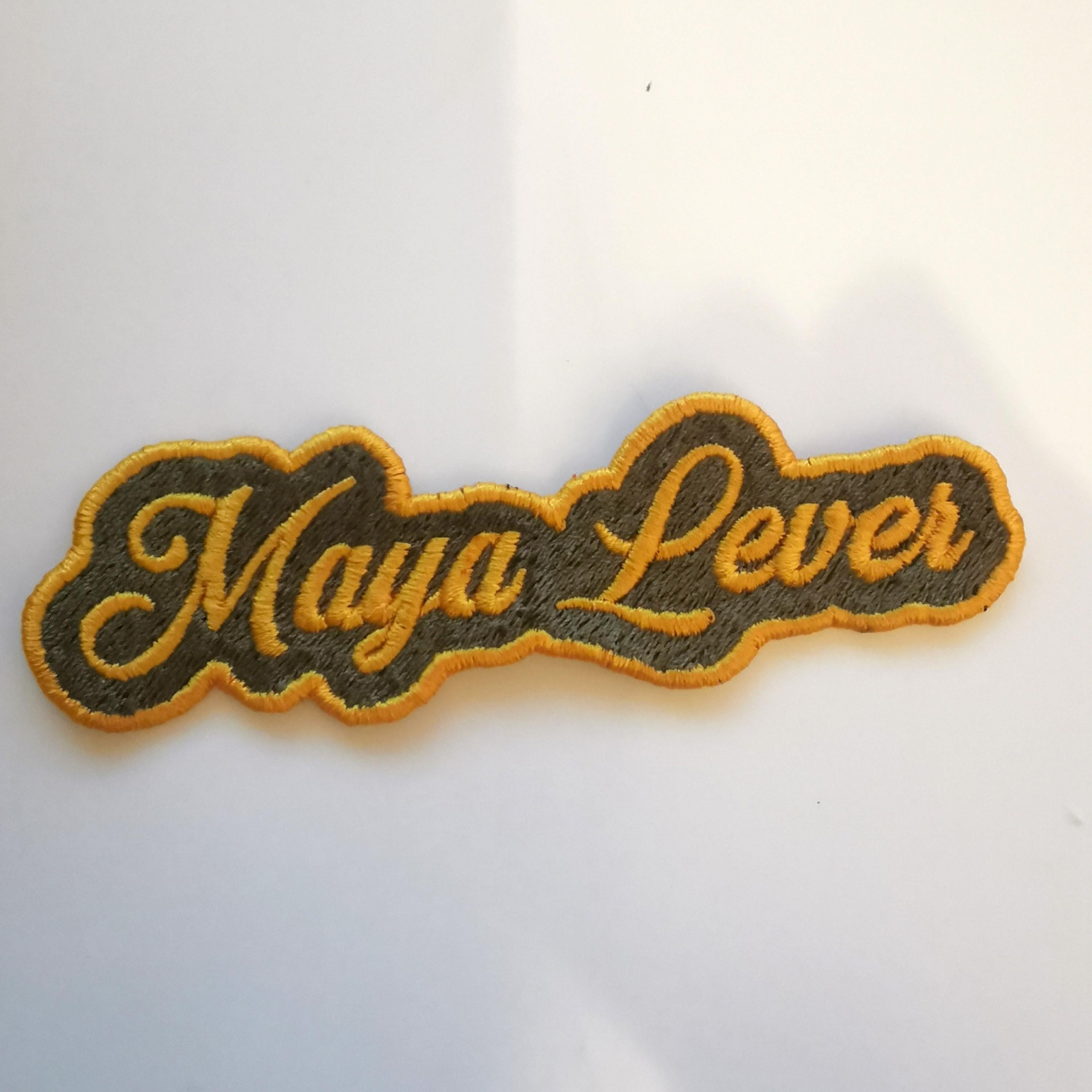 Personalized embroidered patch with the name 'Maya Lever', featuring vibrant colors and easy application.