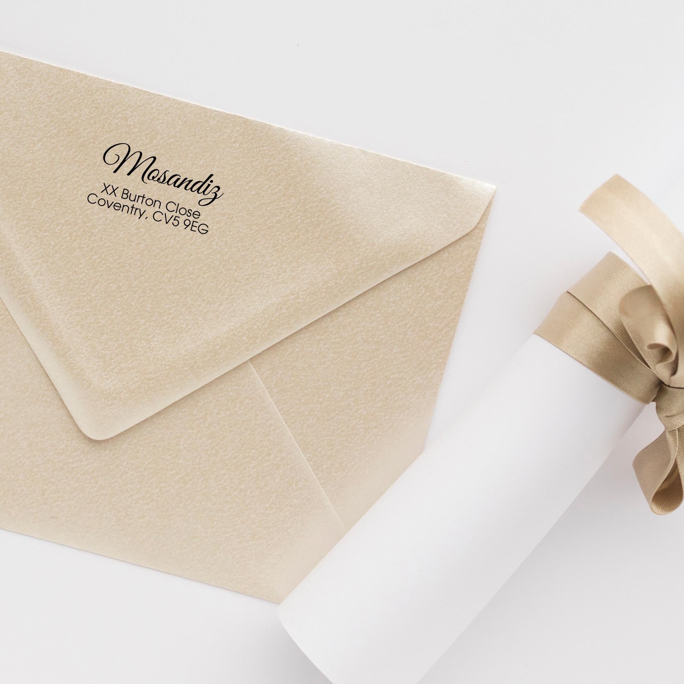 Custom address stamp on elegant ivory envelope with ribbon, showcasing personalization for letters and gifts.