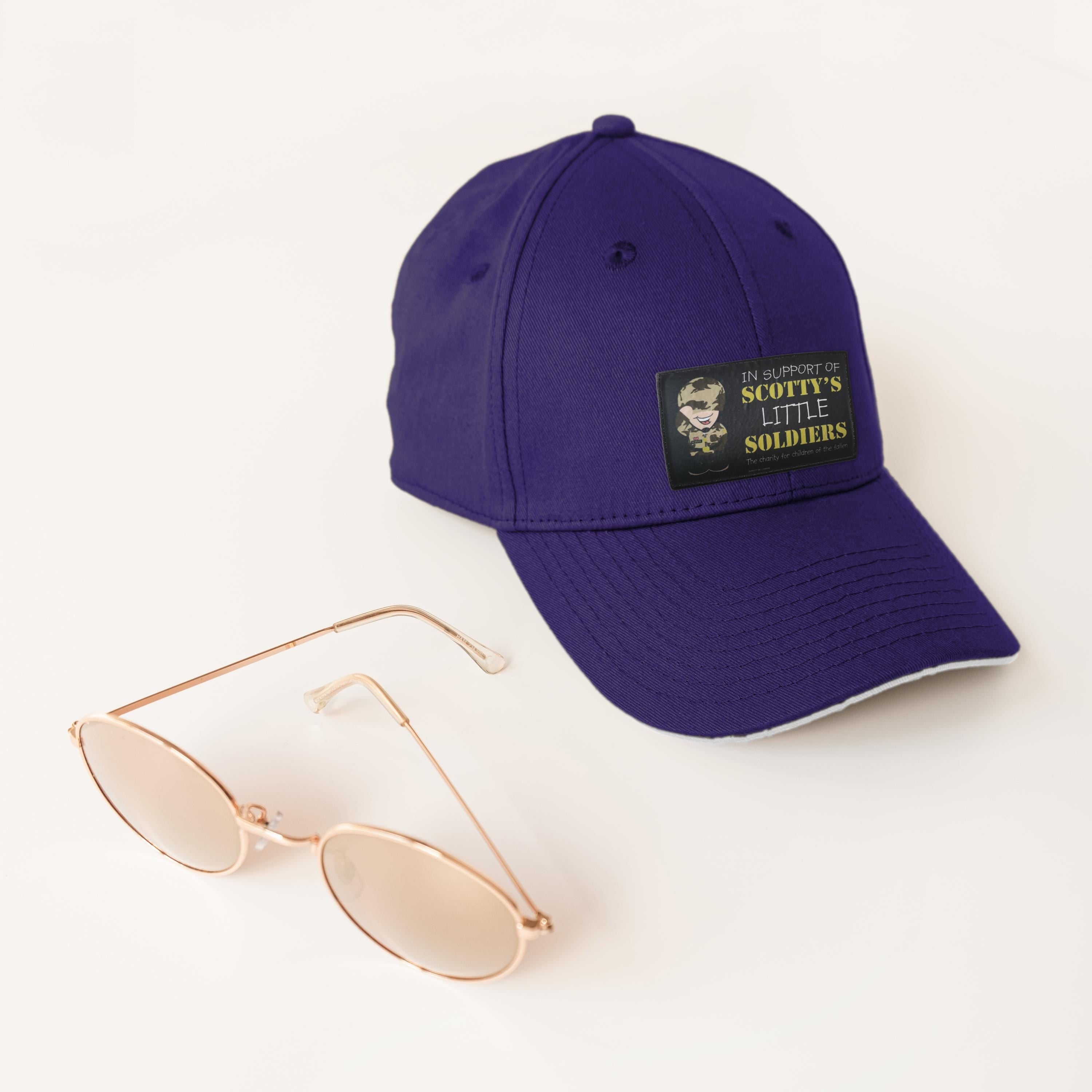 Personalised purple baseball cap with custom patch and sunglasses, perfect for casual wear.