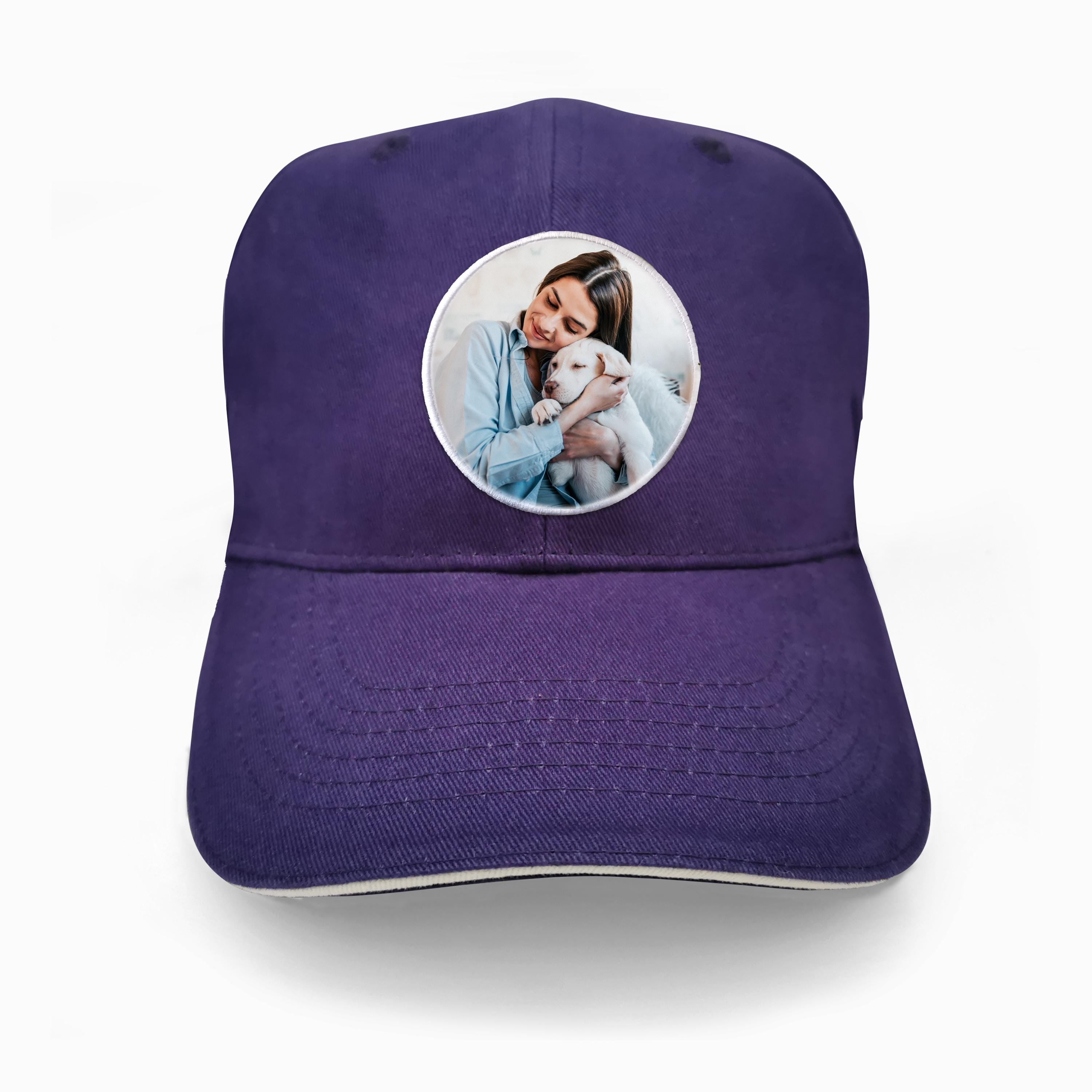 Personalised purple baseball cap featuring custom logo patch, showcasing a woman holding a dog.