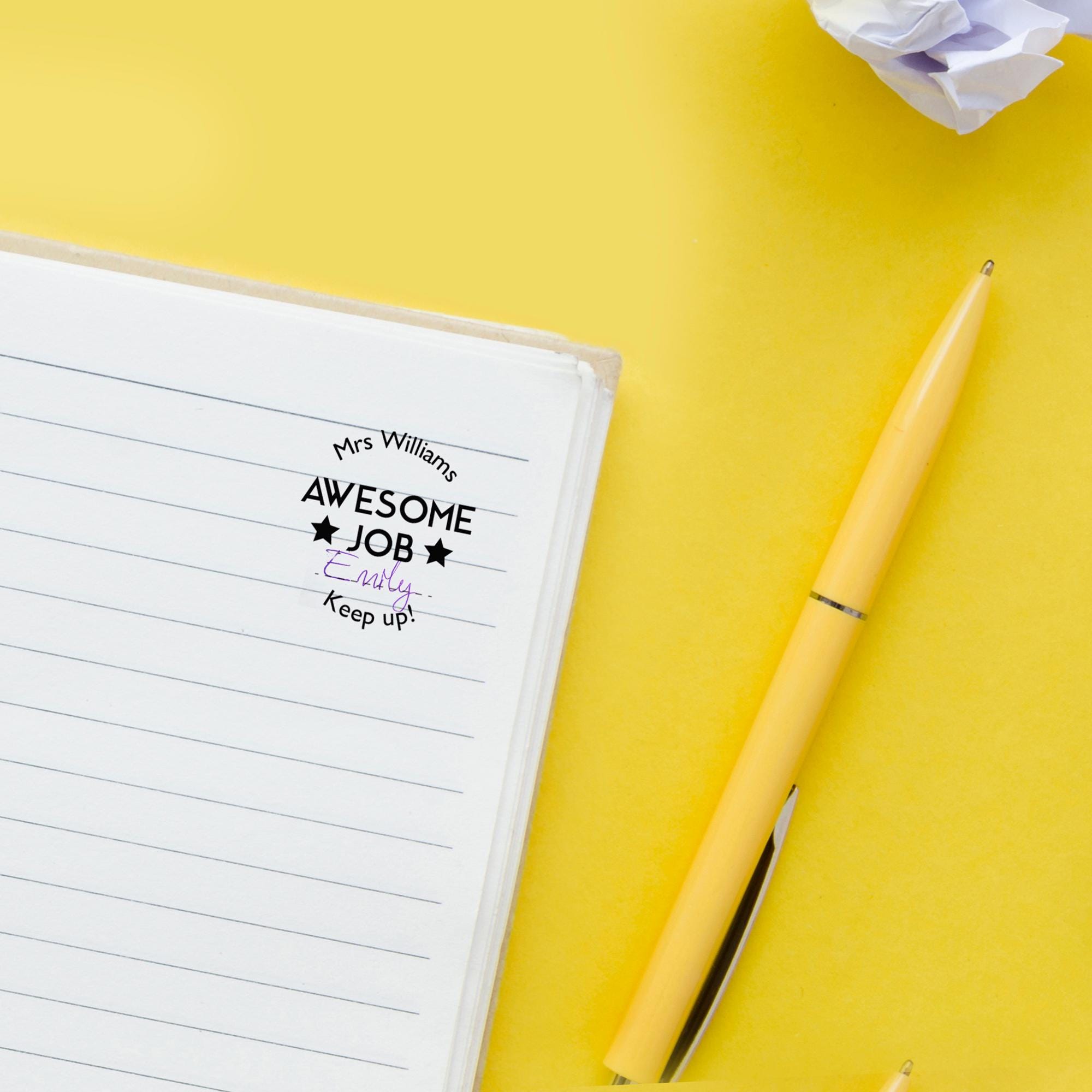 Custom teacher stamp with 'Awesome Job' message on notebook, perfect for homeschooling and motivating students.