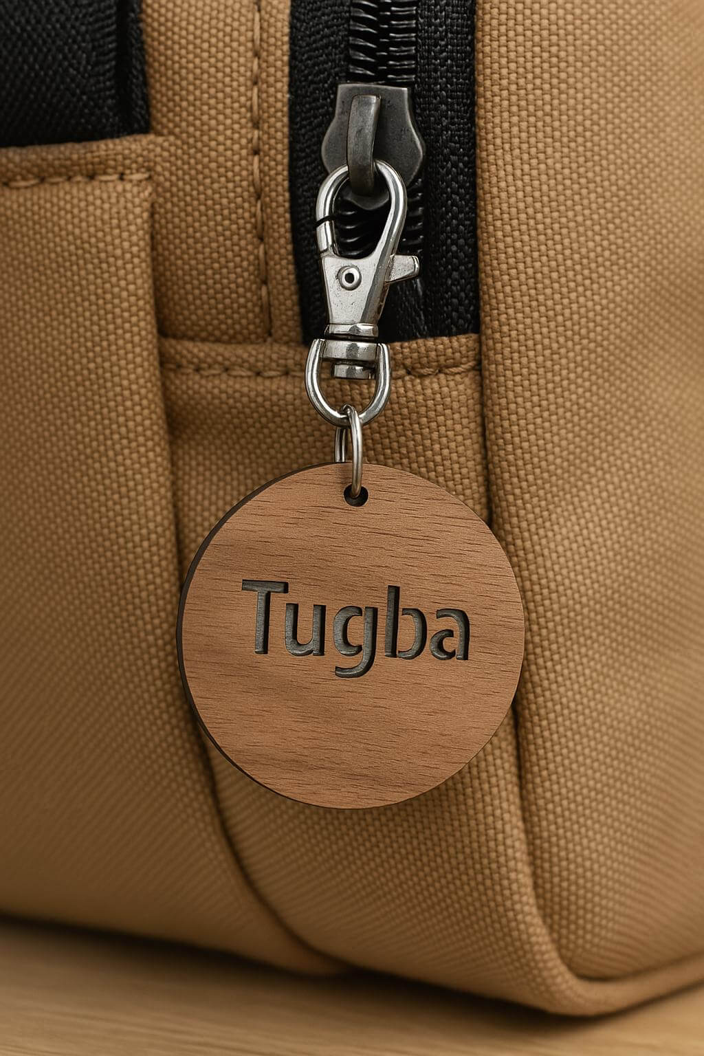 Custom solid walnut wooden keychain with personalized engraving on a stylish bag zipper.