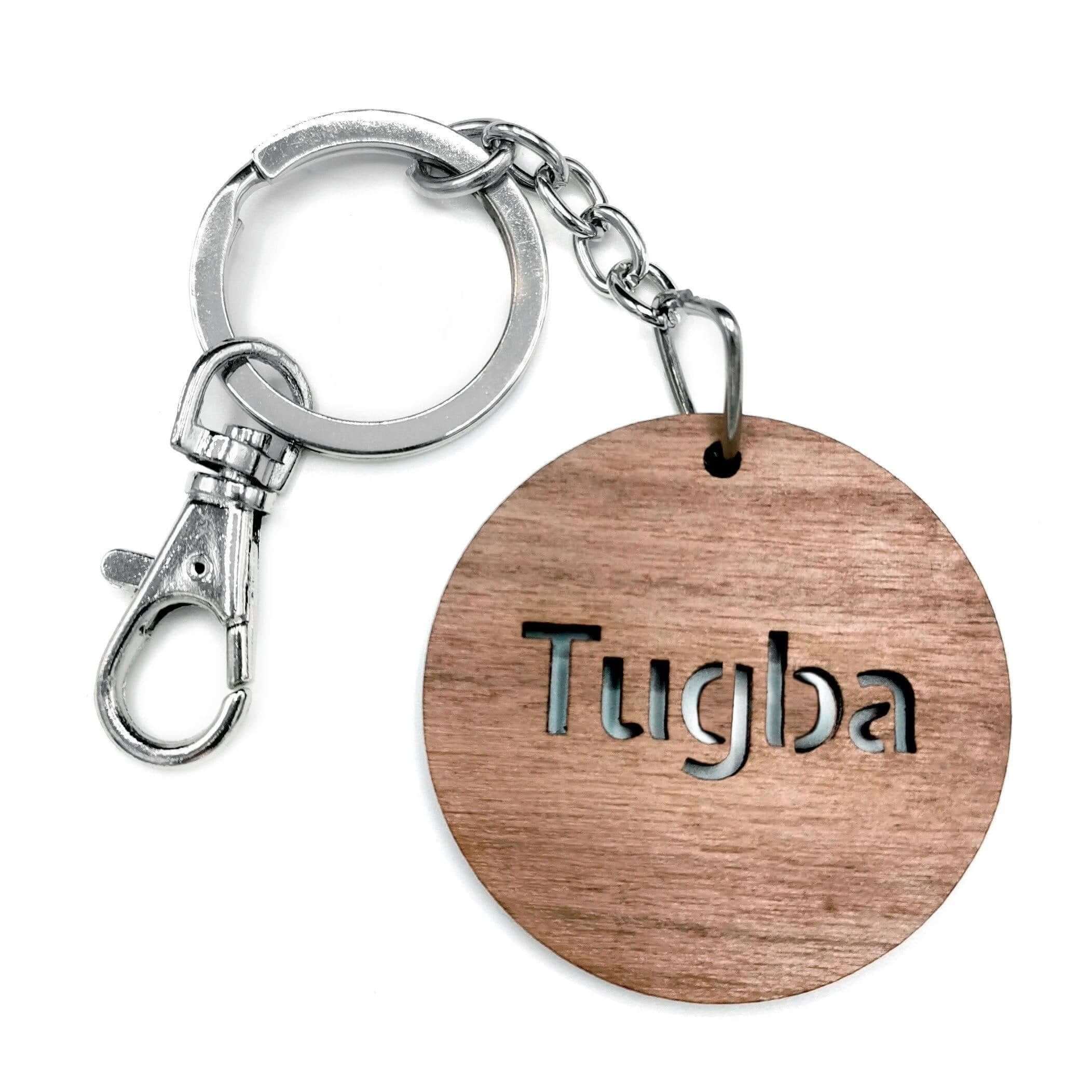 Custom solid walnut wooden keychain with engraved name 'Tugba', perfect for personalized gifts.