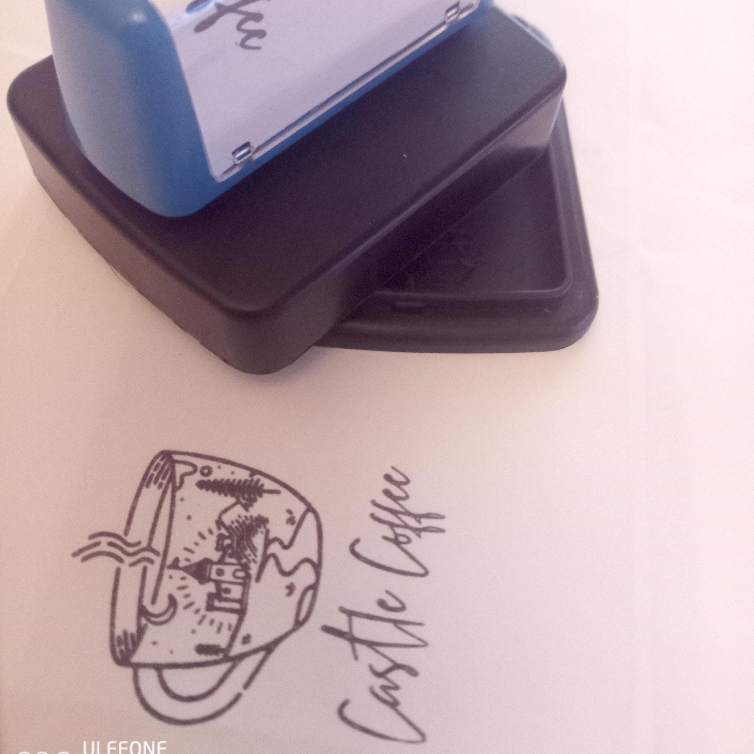 Custom pre-inked logo stamp for Castle Coffee on packaging, showing crisp design and self-inking feature.