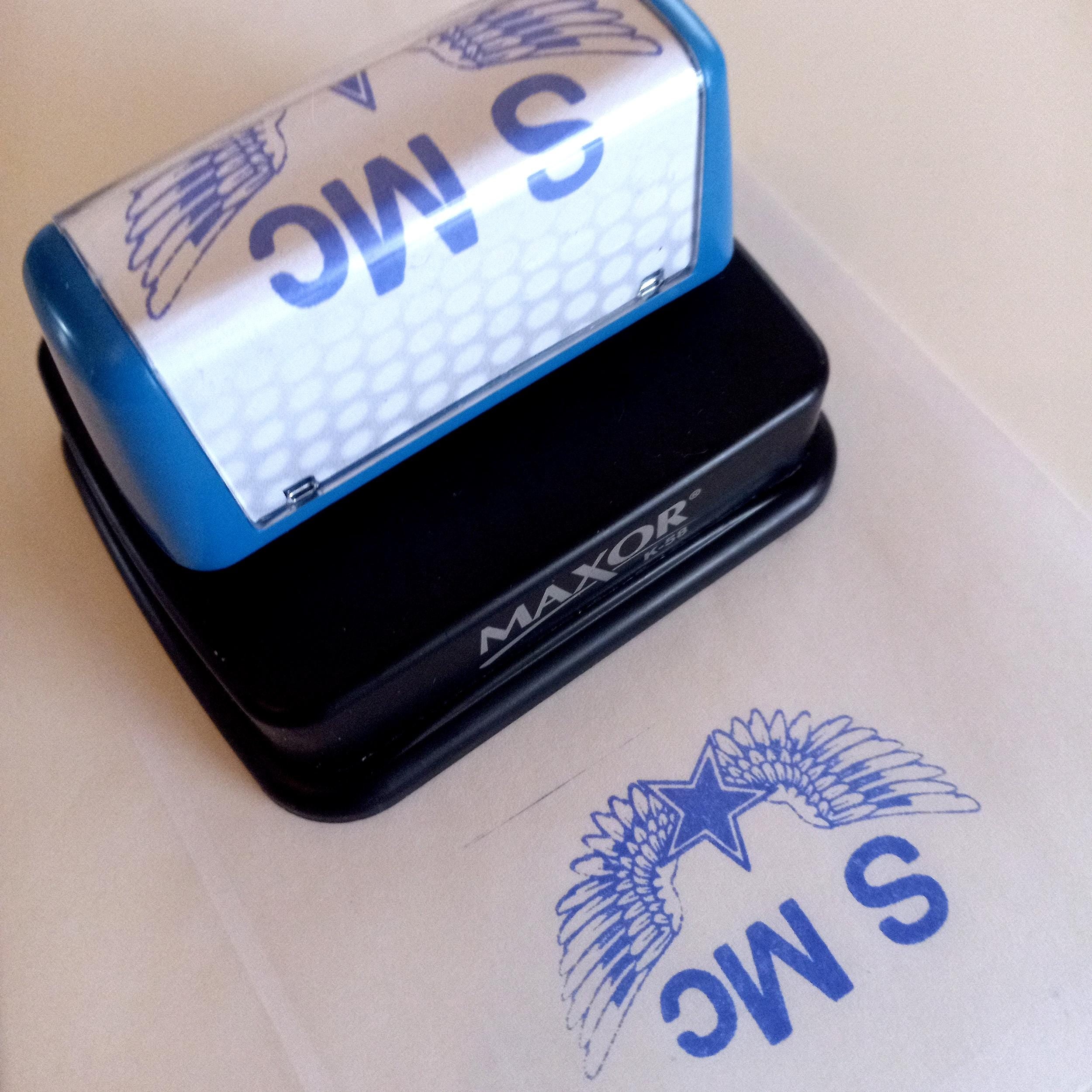 Pre-inked logo stamp showcasing sharp design on paper, perfect for business branding and stationery.