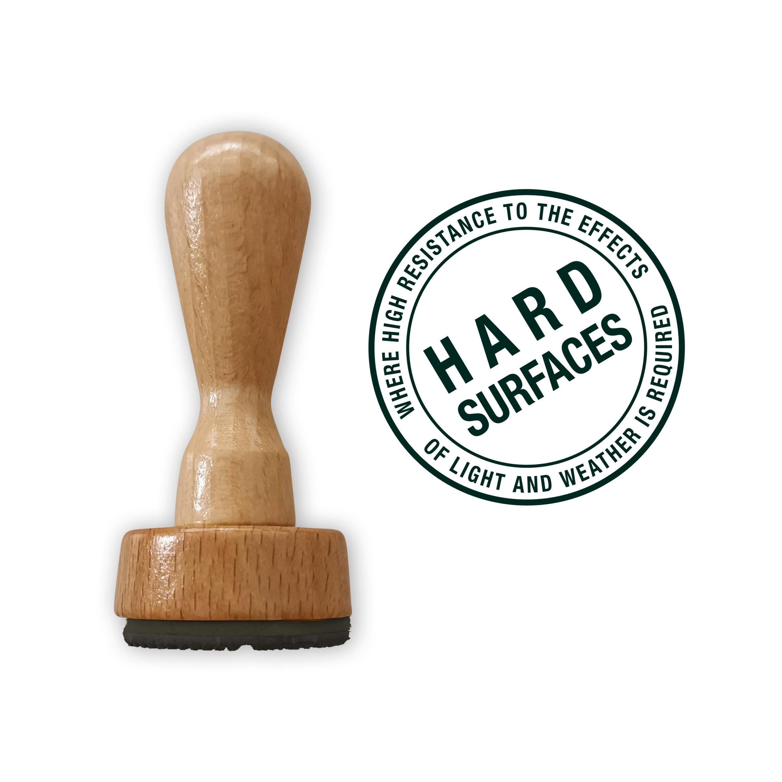 Custom hard surface stamp with wooden handle, designed for durable use on metal, plastic, and wood surfaces.