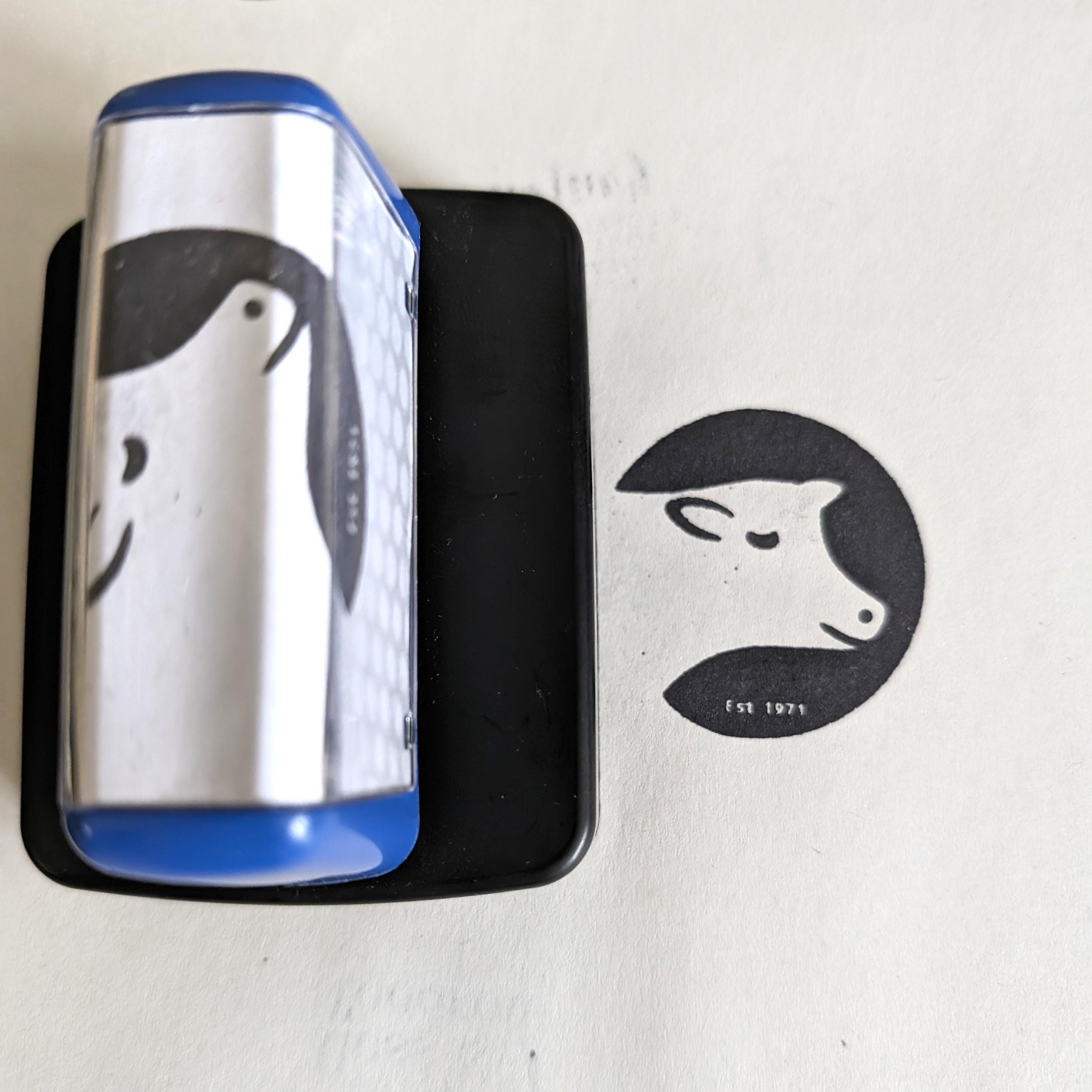 Pre-inked custom logo stamp showing cow design, perfect for branding and packaging.