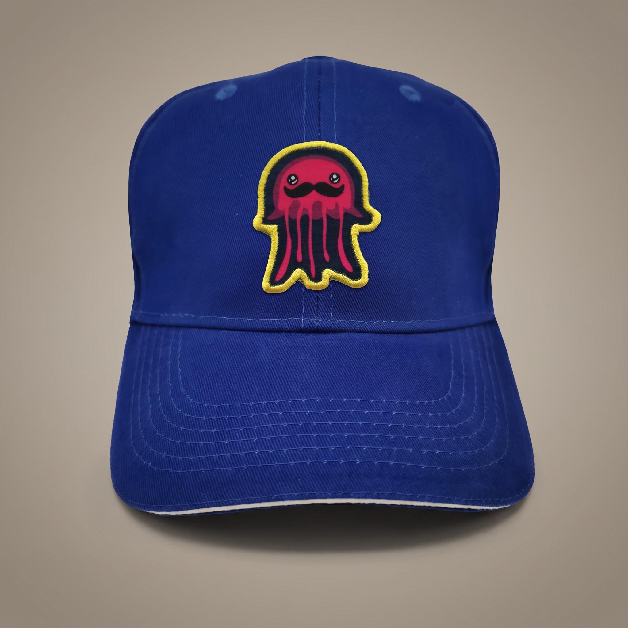 Bright royal blue cap with a vivid printed novelty patch and a flat satin-stitch edge