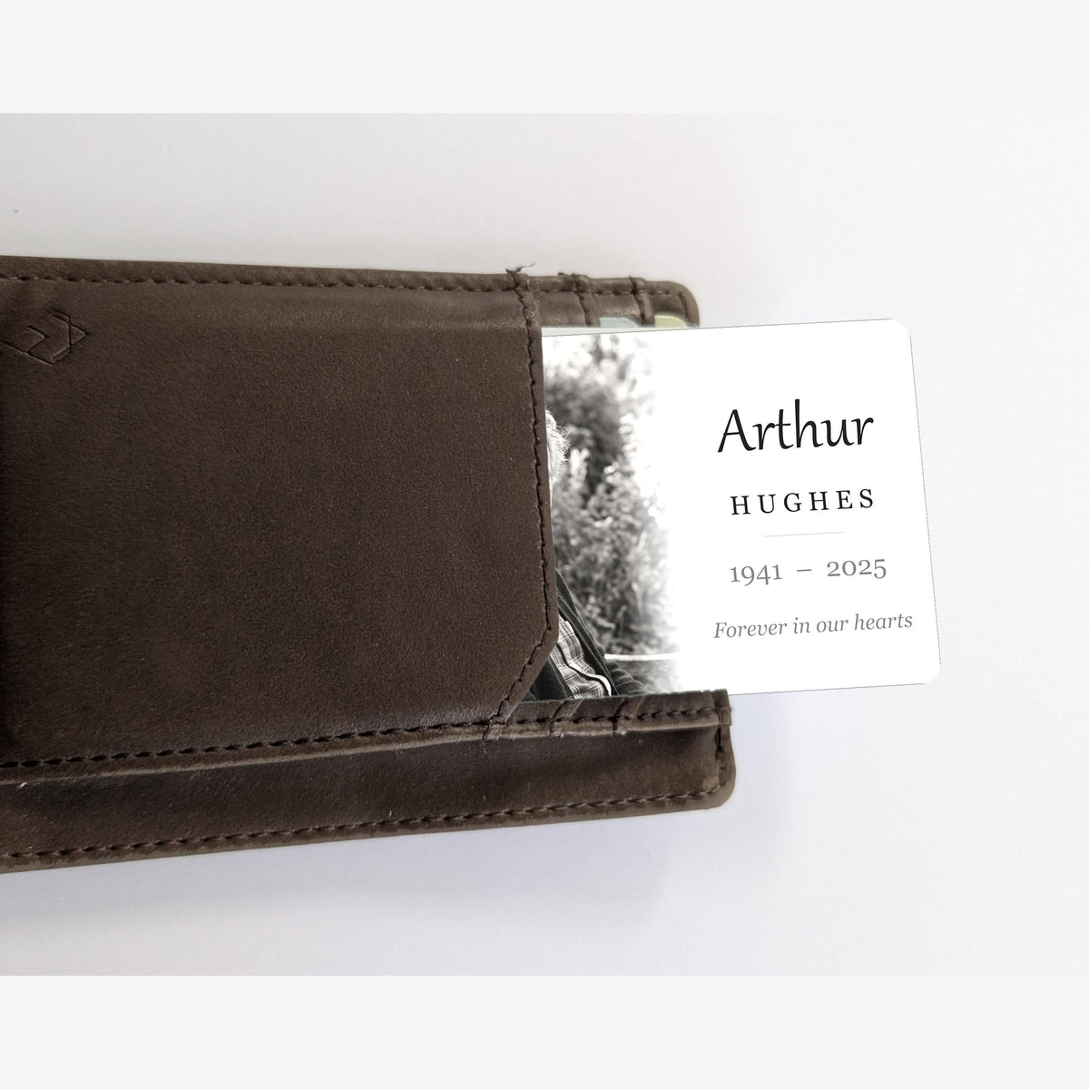 Memorial photo wallet card sliding out of a brown leather wallet card pocket