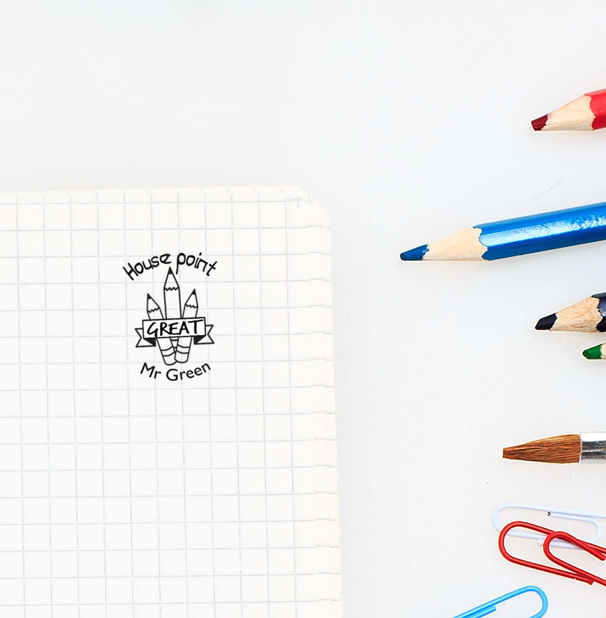 Custom teacher stamp design on notebook, showcasing a personalized library or classroom stamp for teachers.