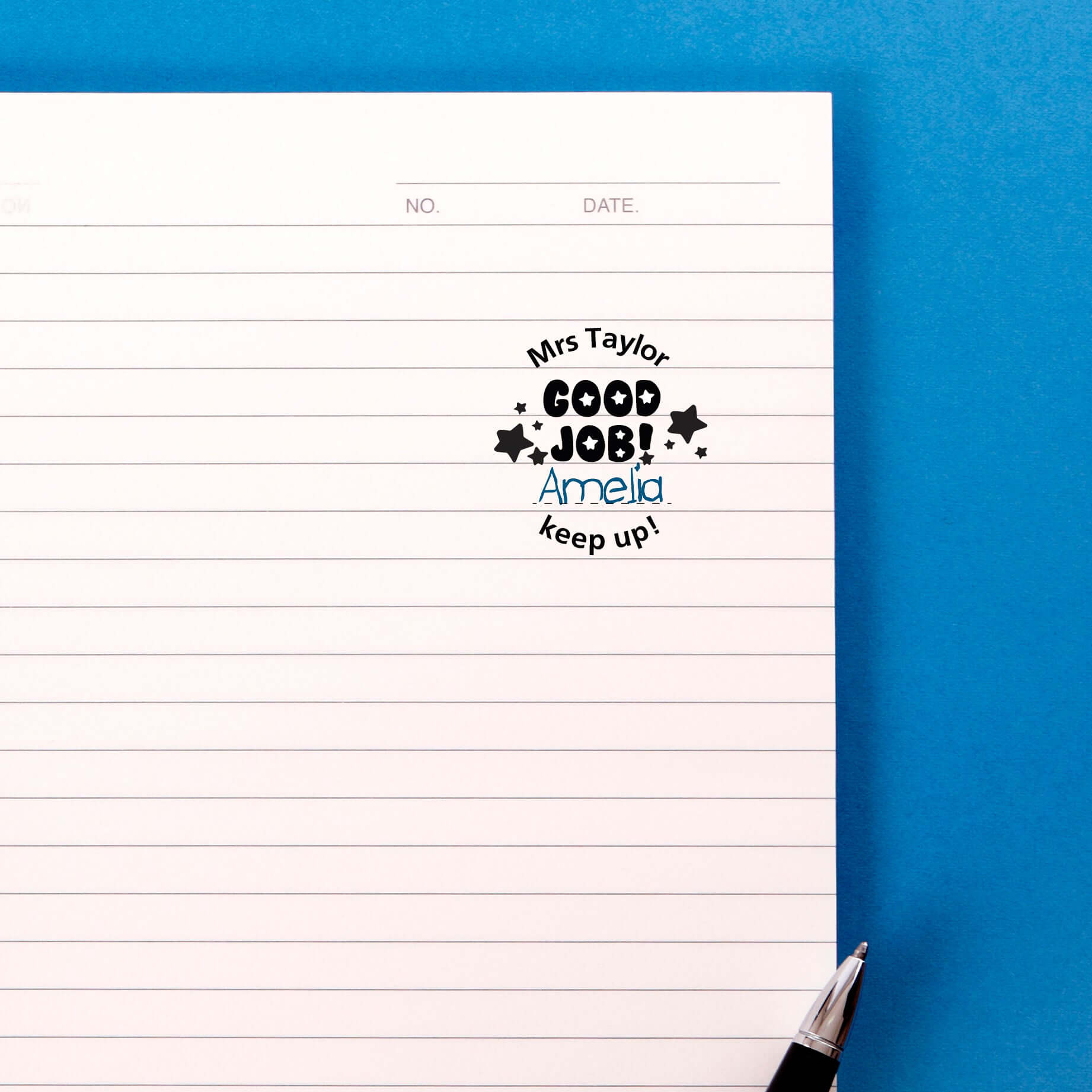 Custom teacher stamp on lined paper displaying message: 'Mrs Taylor GOOD JOB! Amelia keep up!'. Perfect for classroom use.
