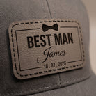 Macro close-up of the engraved leather patch showing black hand stitching and recessed engraving