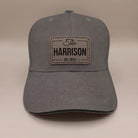 Graphite grey custom leather patch cap with engraved family name badge, The Harrison Est. 2019