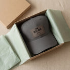 Personalised leather patch cap in a kraft gift box with green tissue paper