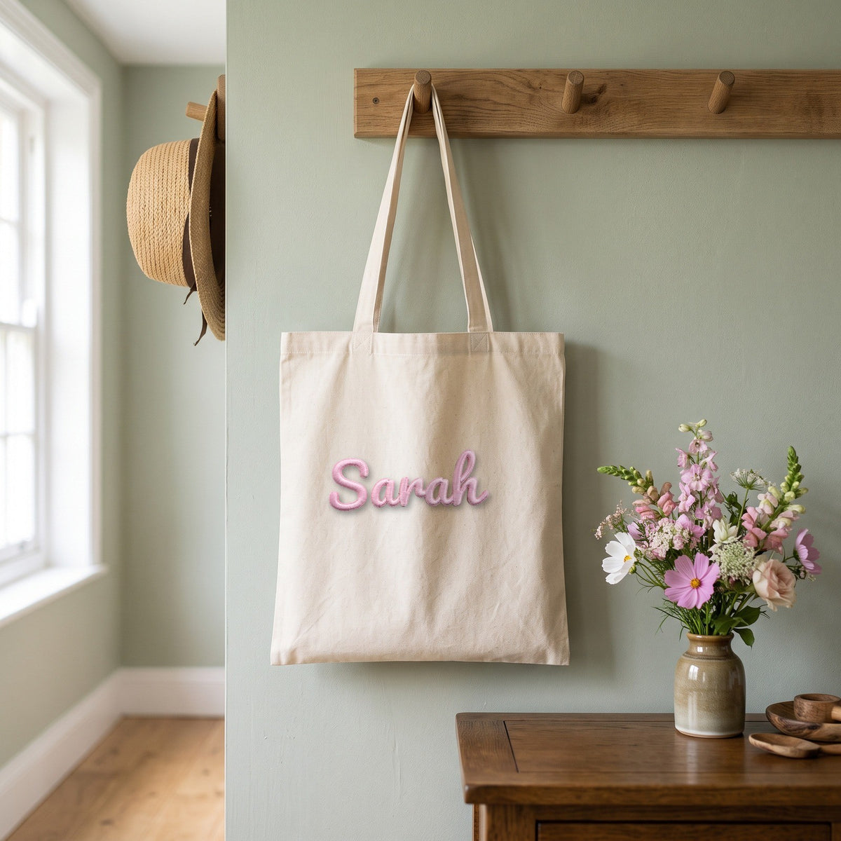 Pink 3D name patch reading Sarah on a natural canvas tote bag