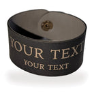 Personalised vegan leather napkin ring in Black/Gold, closed, with two lines of gold engraving