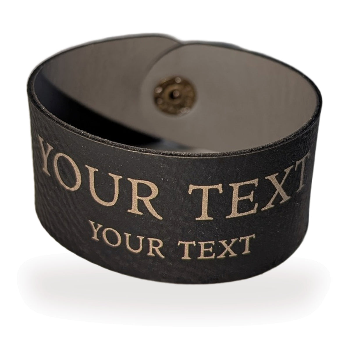 Personalised vegan leather napkin ring in Black/Gold, closed, with two lines of gold engraving