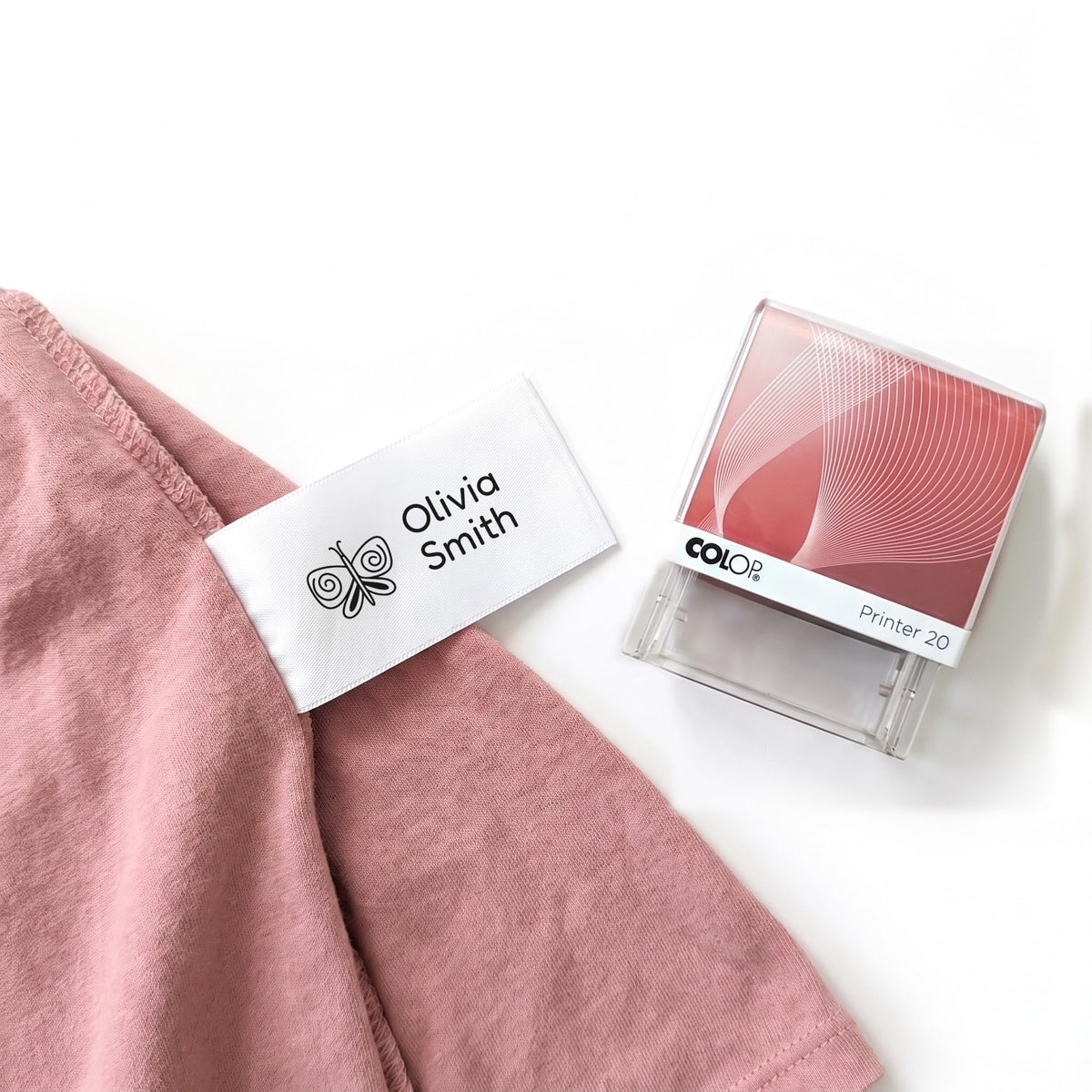 Personalised name stamp for clothes printing a child's name on a white care label