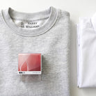 School uniform name stamp in capitals on a grey jumper label