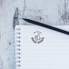 Custom teacher stamp on notebook page, promoting positive feedback for students' work.