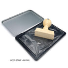 Custom wooden stamp with ink pad for personalized branding and artwork, ideal for small businesses and address labeling.