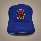 Bright royal blue cap with a vivid printed novelty patch and a flat satin-stitch edge