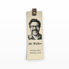 Cream vegan leather bookmark engraved with a portrait, a name and a short quote, with a brown tab and metal snap