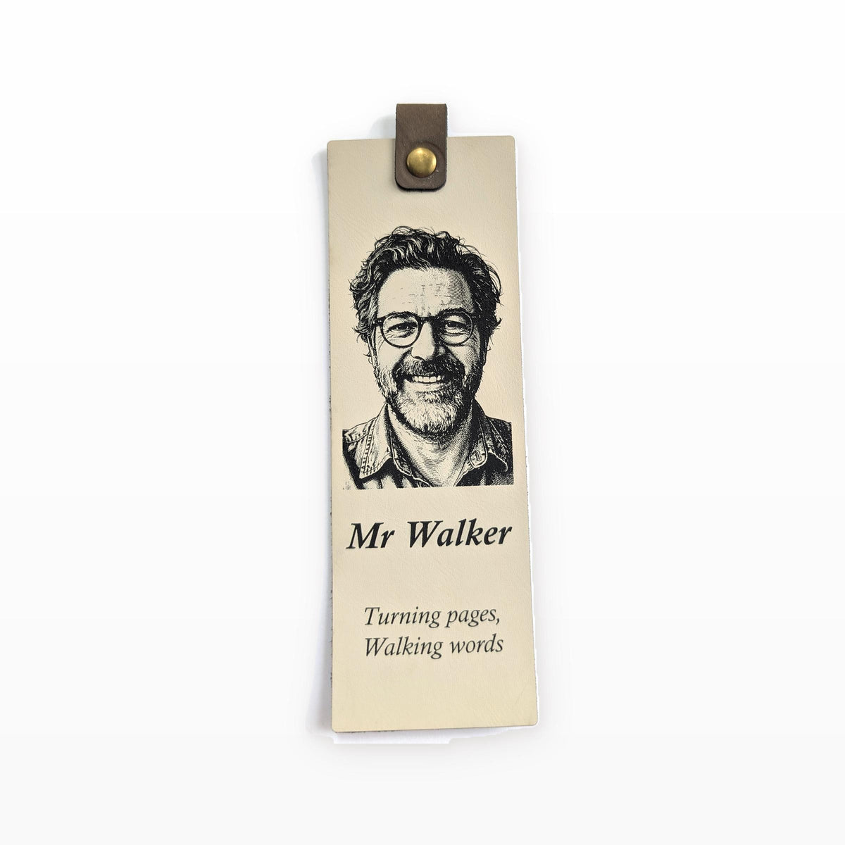 Cream vegan leather bookmark engraved with a portrait, a name and a short quote, with a brown tab and metal snap