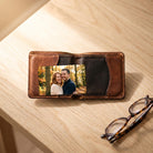 Photo wallet card in the card pocket of an open leather wallet