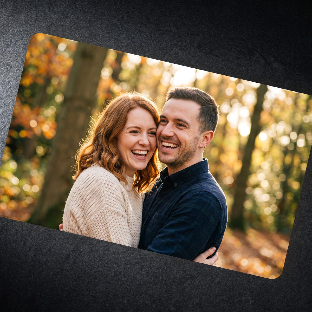 Close view of the photo wallet card on dark slate showing the high gloss finish