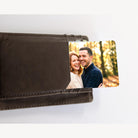 Photo wallet card sliding out of a brown leather wallet card pocket