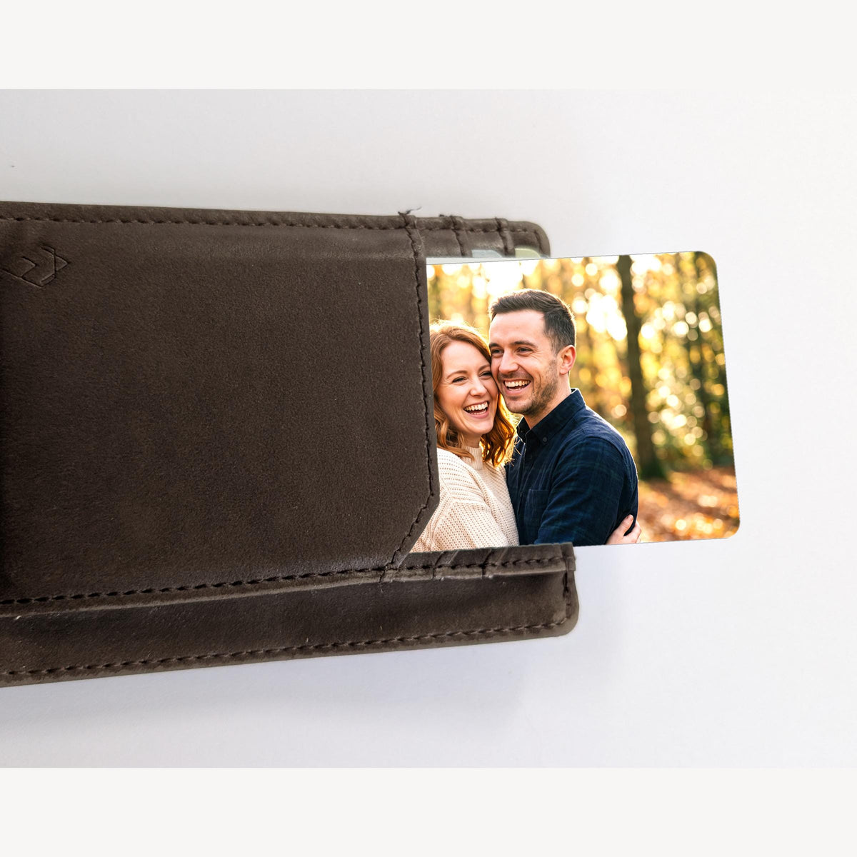 Photo wallet card sliding out of a brown leather wallet card pocket