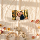 Photo wallet card on cream linen with dried flowers and twine